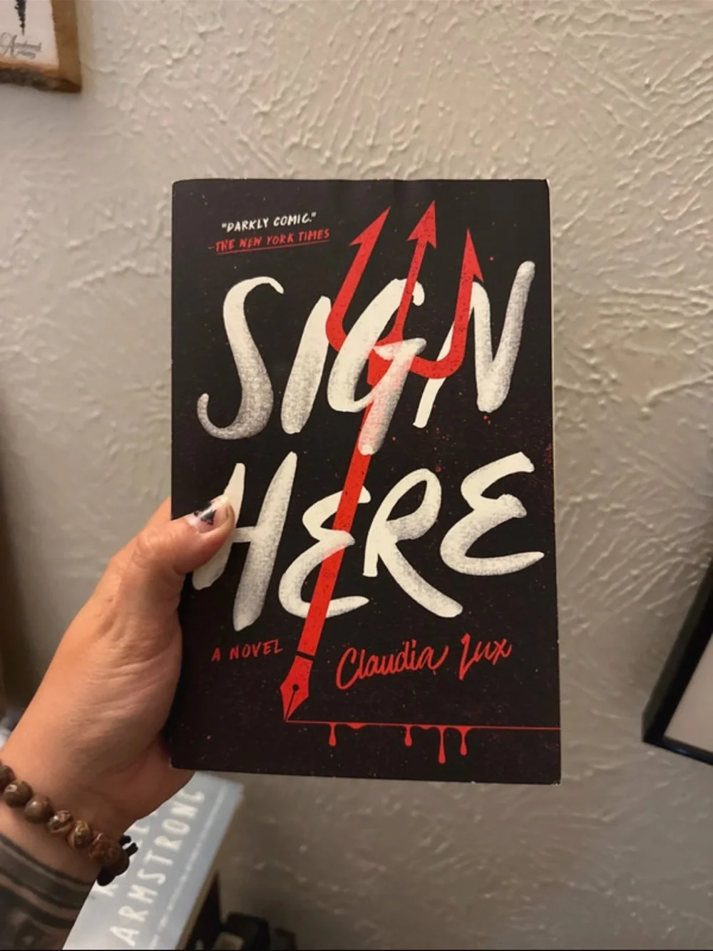 Sign Here by Claudia Lux - Black & Red Paperback Novel